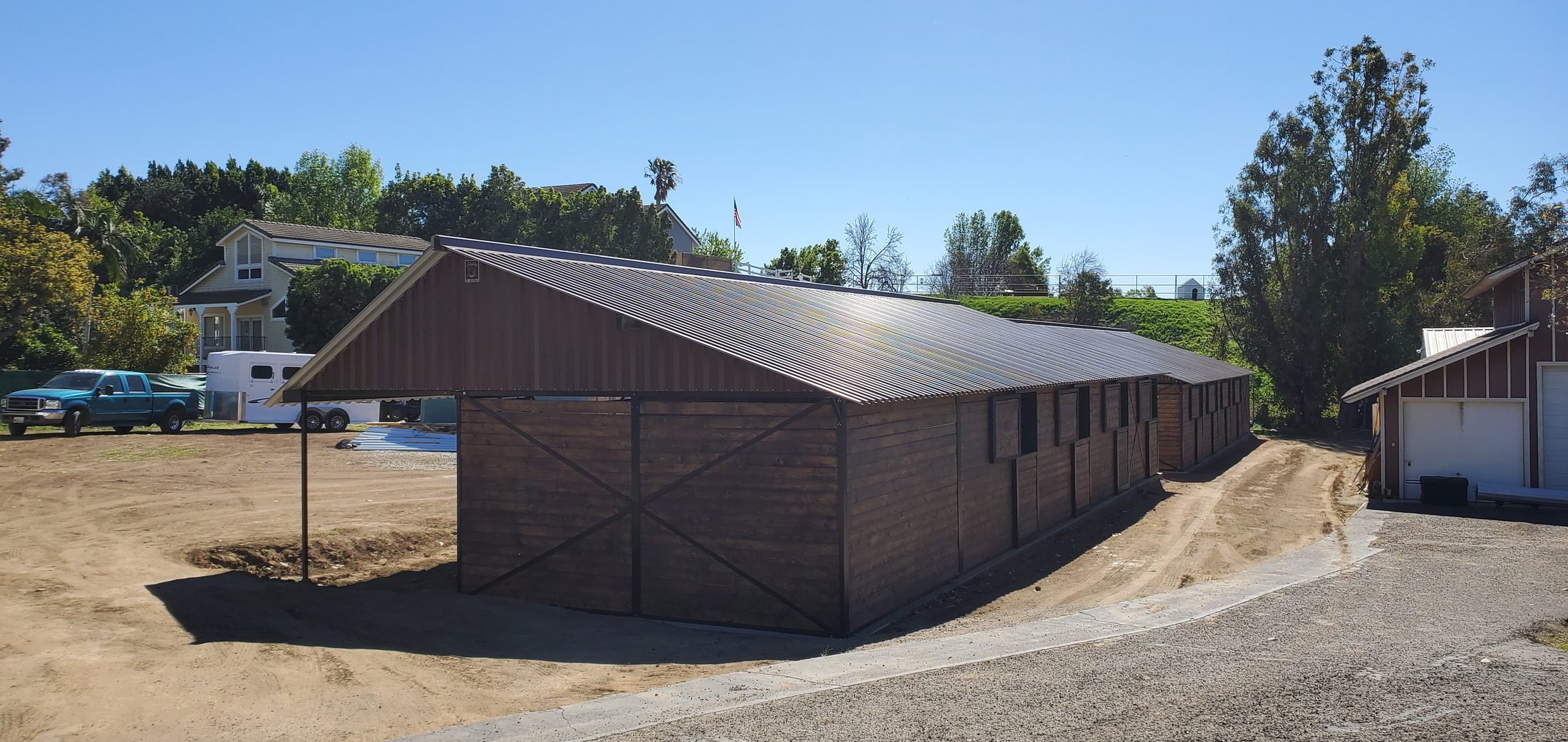 Barn and outbuilding on a Southern California horse property under open sky