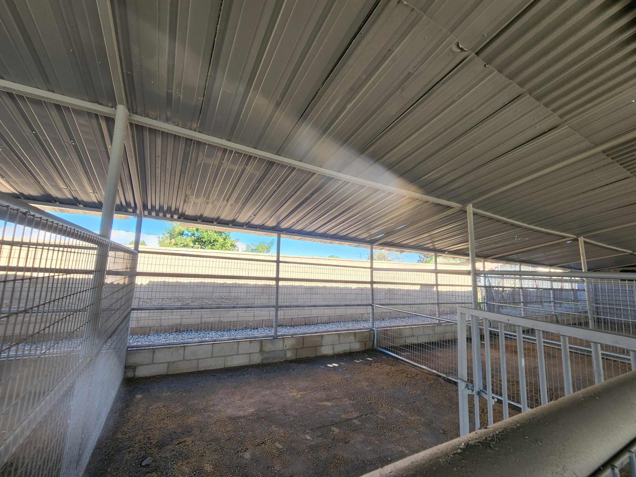 Covered stall with wooden walls on a Southern California horse property